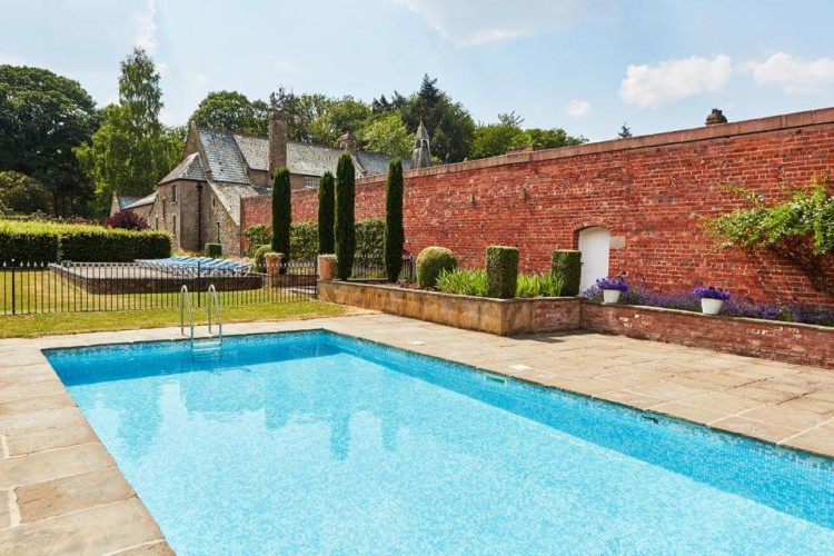 A luxurious outdoor swimming pool at Kington Lodge